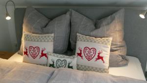 a bed with four pillows on top of it at Ferienwohnung Wiesenglück in Ruhpolding