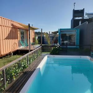 a swimming pool on a deck next to a house at Casacubo Necochea in Necochea