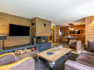 a living room with a fireplace and a tv at Appartement de prestige avec cheminée, balcon et wifi à Val-d'Isère - FR-1-694-320 in Val dʼIsère