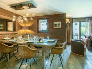 a dining room with a table and chairs at Appartement de prestige avec cheminée, balcon et wifi à Val-d'Isère - FR-1-694-320 in Val dʼIsère