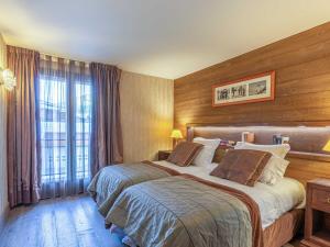 a hotel room with two beds and a window at Appartement de prestige avec cheminée, balcon et wifi à Val-d'Isère - FR-1-694-320 in Val dʼIsère