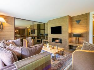 a living room with a couch and a fireplace at Appartement de standing avec balcon ensoleillé, 3 chambres, au cœur de Val-d'Isère - FR-1-694-322 in Val dʼIsère