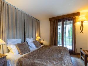 a bedroom with a bed and a large window at Appartement de standing avec balcon ensoleillé, 3 chambres, au cœur de Val-d'Isère - FR-1-694-322 in Val dʼIsère
