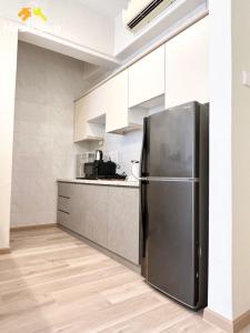a kitchen with a stainless steel refrigerator at Costa Mahkota Suites Malacca Central By Nestcove in Melaka