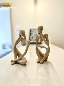 a couple of wooden figurines sitting on a counter at Costa Mahkota Suites Malacca Central By Nestcove in Melaka