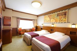 a hotel room with two beds and a table at Tokyo Bay Maihama Hotel First Resort in Urayasu +62 photos