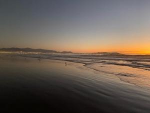 a view of a beach at sunset at Cond. Portal pacifico III in La Serena