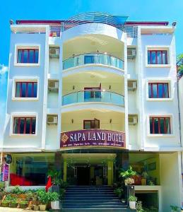 a large white building with a sara land hotel at Sapa Land Hotel in Sapa