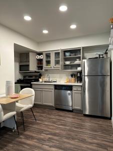a kitchen with a stainless steel refrigerator and a table at Studio Unit in the MedCenter in Houston