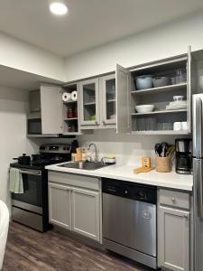 a kitchen with stainless steel appliances and white cabinets at Studio Unit in the MedCenter in Houston