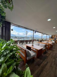 a restaurant with benches and tables and a view of the ocean at Kathmandu Height Boutique Hotel in Kathmandu