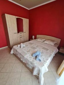 um quarto com uma cama grande e paredes vermelhas em Giotas House-free parking em Drama