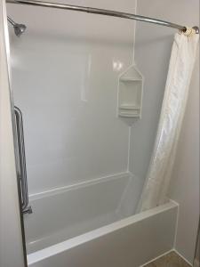 a bathroom with a shower with a bath tub at 2400 Motel in Vancouver