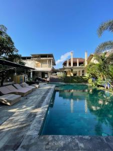 an image of a swimming pool at a resort at Tri Putri Kuta Homestay in Kuta Lombok