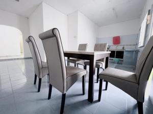 a dining room with a table and chairs at You can sleep well in Sungai Petani