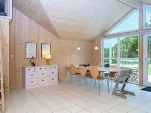 a dining room with a table and chairs at 6 person holiday home in Oksbøl-By Traum in Oksbøl