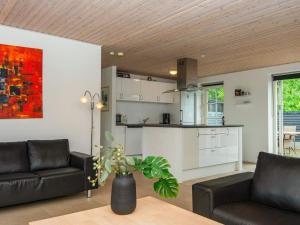 a living room with a couch and a kitchen at 12 person holiday home in Ulfborg in Øby