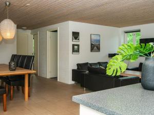 a living room with a couch and a table at 12 person holiday home in Ulfborg in Øby