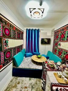a room with a bed and a table in it at Guest house by Sayohati Diyor in Dushanbe