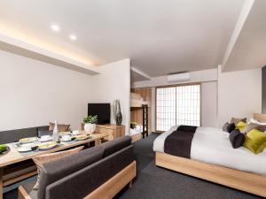 a bedroom with a bed and a desk and chairs at MIMARU Tokyo Ginza East in Tokyo +39 photos