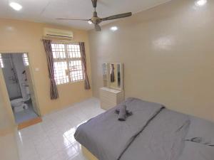 a bedroom with a bed and a bathroom at Welcome Home in Sungai Petani