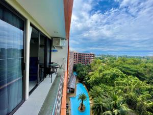 an apartment balcony with a view of the jungle at Mai Khao Beach Condotel - family condo in 600 meters to beach in Ban Bo Sai Klang
