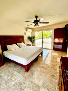a bedroom with a bed and a ceiling fan at Villa Marina in Puerto Vallarta