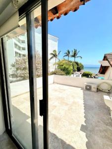 a view of the ocean from the balcony of a house at Villa Marina in Puerto Vallarta