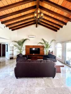 a living room with a couch and a television at Villa Marina in Puerto Vallarta