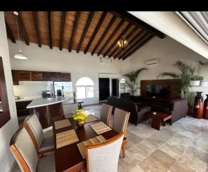 a living room with a dining table and a kitchen at Villa Marina in Puerto Vallarta
