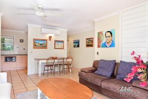 a living room with a couch and a table at Yaringa Apartment 1 - Moments from Noosa Main Beach in Noosa Heads