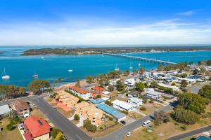 an aerial view of a town next to the water at Winston Waves in Bongaree