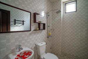 a bathroom with a toilet and a sink and a shower at Hoi An Viet House Homestay in Hoi An