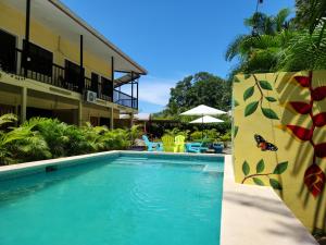 a swimming pool in front of a hotel at Family Hotel in Puerto Viejo