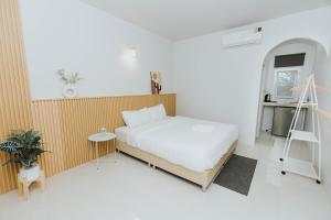 1 dormitorio con cama y escalera en Ramida House บ้านรมิดา, en Ban Sao Thong