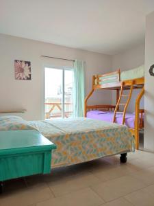 a bedroom with two bunk beds and a balcony at Villa Luna frente al mar in Manta