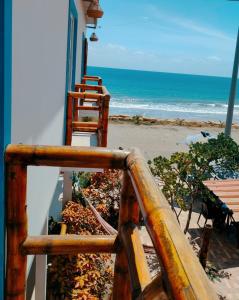 a wooden staircase leading up to a beach with a house at Villa Luna frente al mar in Manta