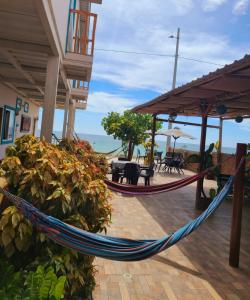 a hammock on a porch of a beach house at Villa Luna frente al mar in Manta