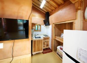 a tv on the wall of a tiny house at Danyang Hanok 단양한옥가대리 in Danyang