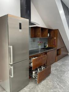 a kitchen with a stainless steel refrigerator and a sink at Green Bay Luxury Villa Sonasea Vân Đồn in Thâm Câu