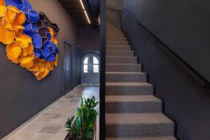 a staircase in a house with a colorful chandelier at The Sendal Boutique Hotel in Nicosia