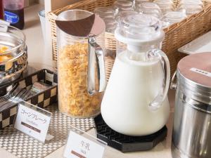 a jar of milk on a counter with food at Vessel Hotel Fukuyama in Fukuyama