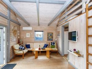 a living room with a table and a couch at Holiday home Hovborg XII in Hovborg