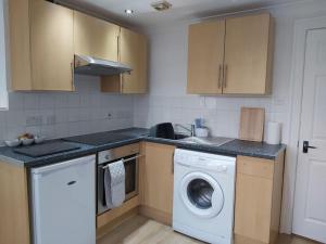 a kitchen with a washing machine and a washer at #4 The Quirky Quarters in Portsmouth