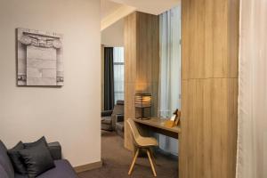 a hotel room with a desk and a room at Republica Hotel Yerevan in Yerevan