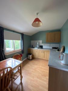 a kitchen with a table and a dining room at PINEBROOK BnB 1st Floor Apartment shared bathroom budget in Killybegs