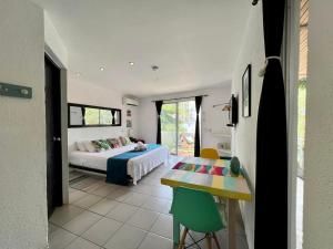 a bedroom with a bed and a table in a room at Ocean Lovers Apartamentos in Taganga