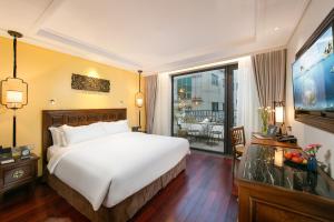a hotel room with a bed and a large window at Lucien Hanoi Lakeside Hotel & Rooftop in Hanoi