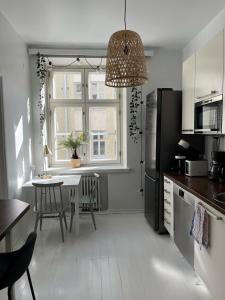 a kitchen with a table and a dining room at Design stay in the heart of Punavuori in Helsinki