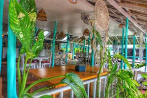 a restaurant with a table and some plants at The Mermaid House in Ko Kood